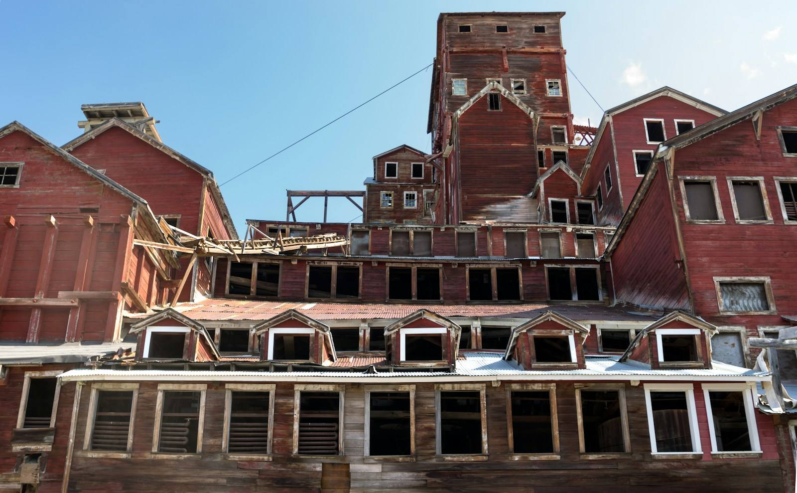 The remnants of the Kennecott stamp mill are several stories high along the Kennecott Glacier