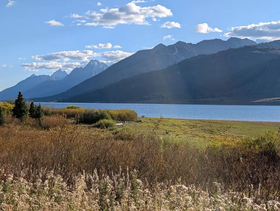 The Teton Range rising above Jackson Lake with fall grasses in front